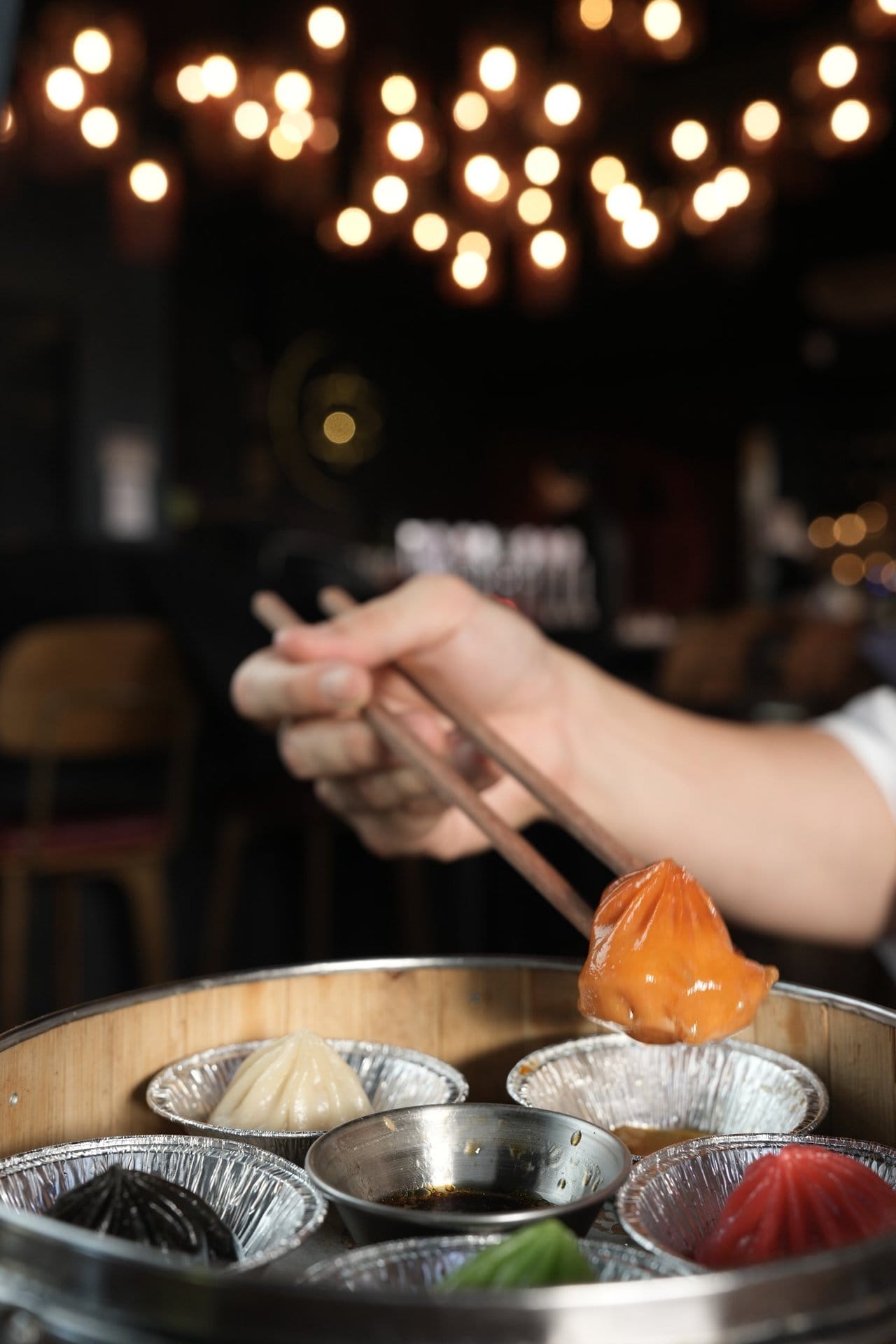Small plates spread across a Lucky 8 table — steamer, bao and grill